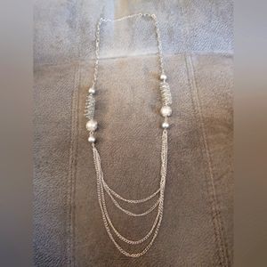 Necklace likely nickel etc as it is a ferous metal (sticks to a magnet) 19 inch